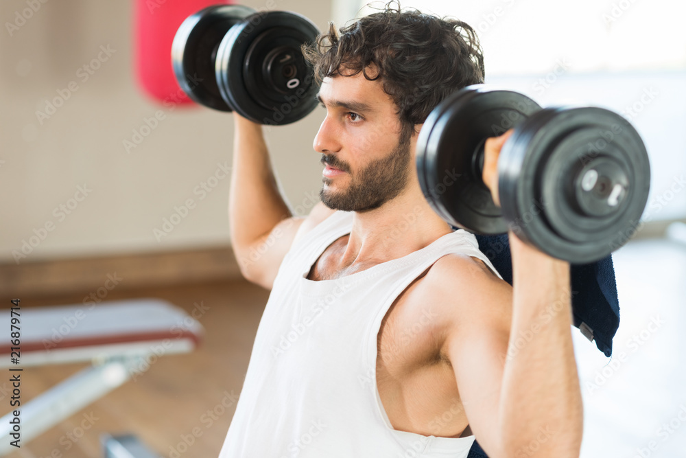 Bodybuilder lifting dumbbells Bodybuilder lifting dumbbells