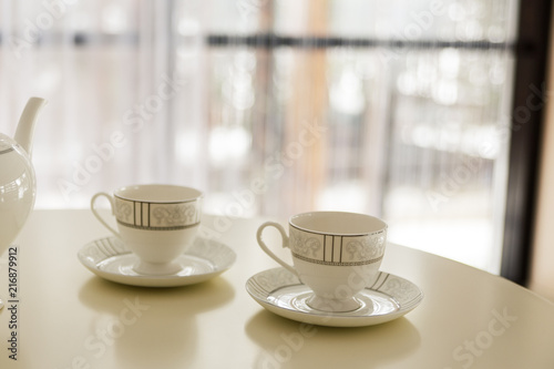 Two cups for tea on the table. Bokeh and blurred background. Selective focus. Copy space.
