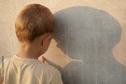 sad little boy near the wall