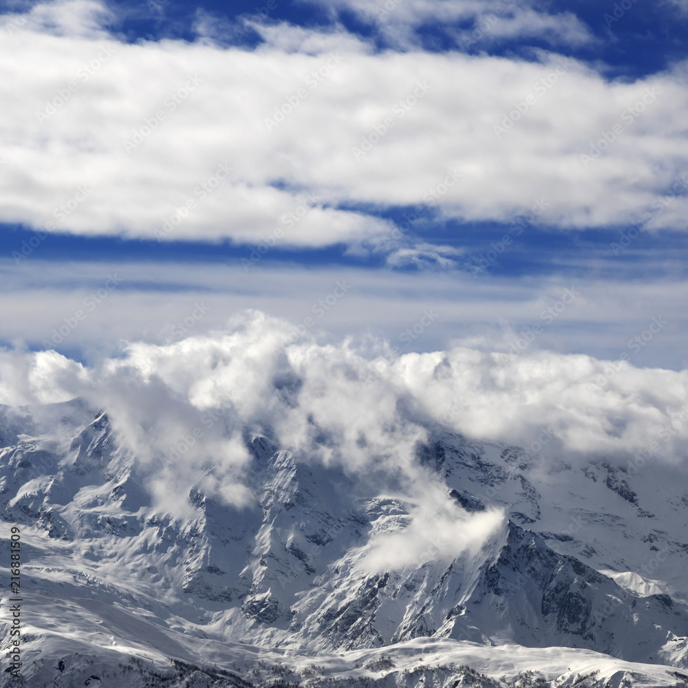 Snow winter mountains in clouds at sun day Snow winter mountains in clouds at sun day
