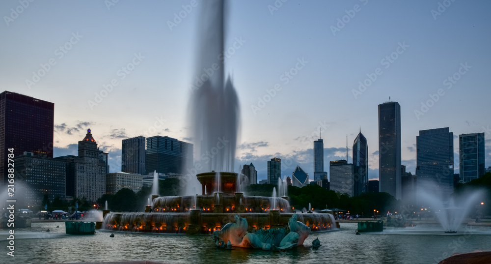 water fountain in big city at dusk
