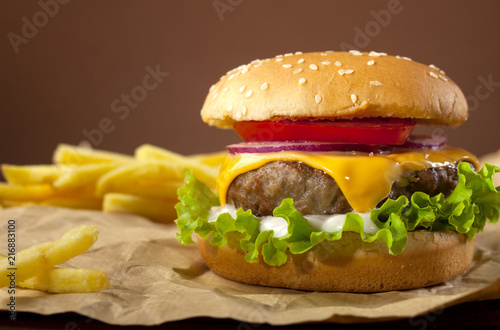Fresh delicious burger on a wooden background photo