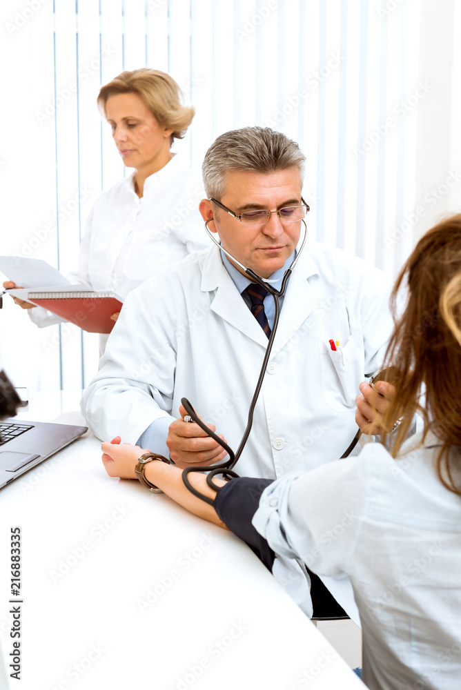 Fototapeta premium Offering his expert advice to his patient