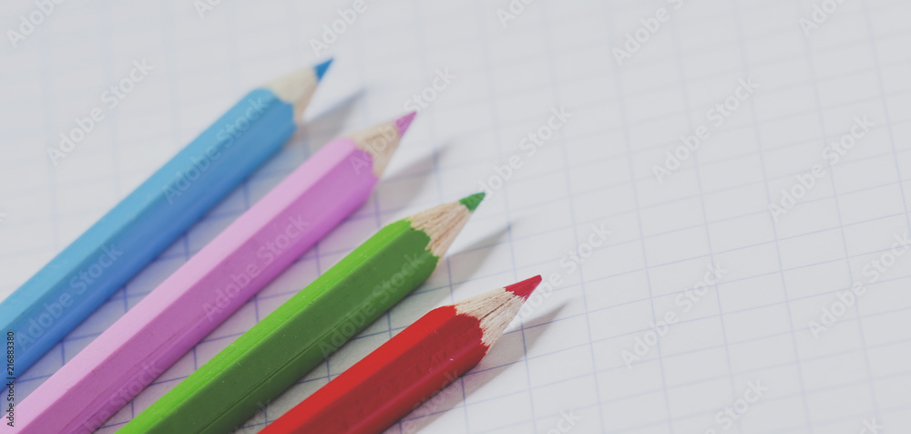Pink school notebook in the box and colored pencils, selective focus and toned image Pink school notebook in the box and colored pencils, selective focus and toned image