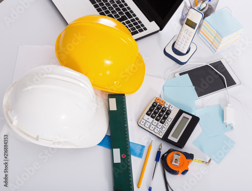 Helmets, level, calculator, roulette on the table