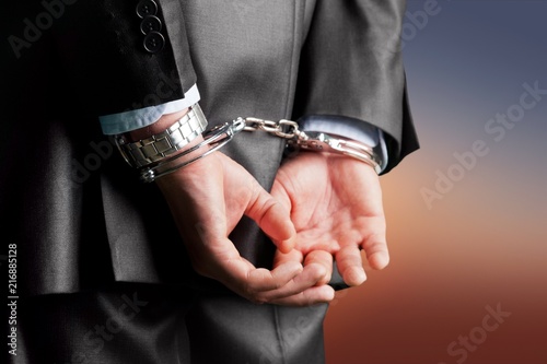 Cropped image of male hands in handcuffs