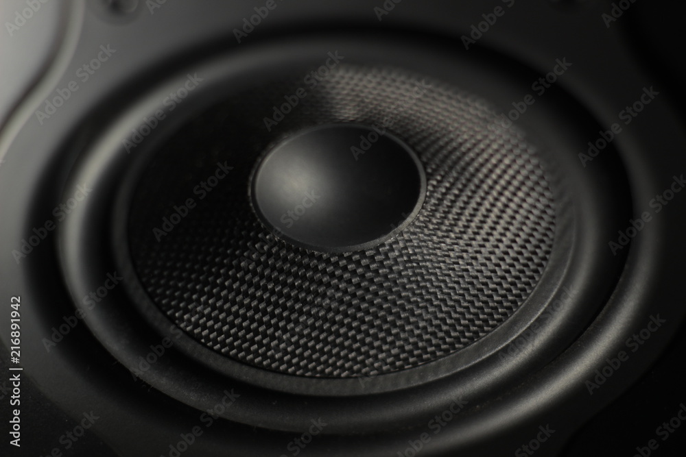 Close up of a cone of a studio speaker (black). Concept: tweeter, subwoofer, audio, recording, music, technology Close up of a cone of a studio speaker (black). Concept: tweeter, subwoofer, audio, recording, music, technology