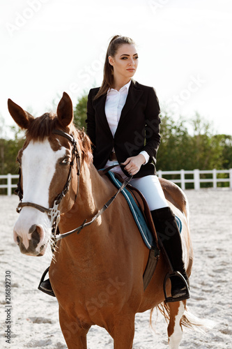 Rider elegant woman riding her horse outside