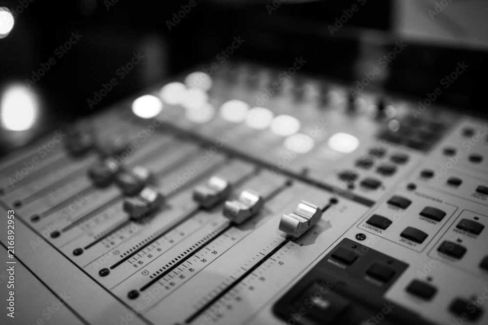 Sound recording studio mixing desk. Music mixer control panel. Closeup. Selective focus. Black and White image Sound recording studio mixing desk. Music mixer control panel. Closeup. Selective focus. Black and White image
