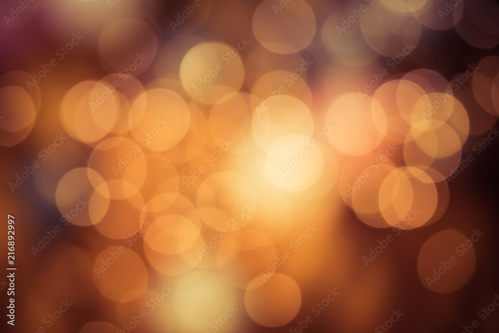 Fototapeta premium Bright round bokeh on orange background