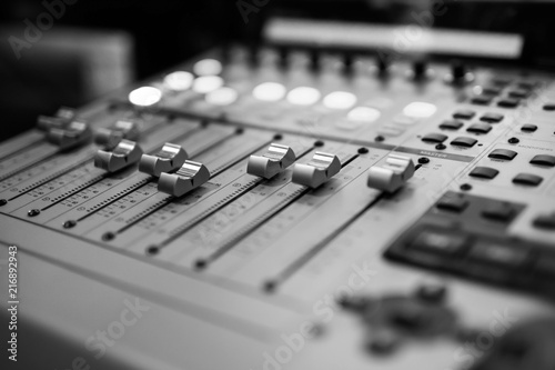 Sound recording studio mixing desk. Music mixer control panel. Closeup. Selective focus. Black and White image