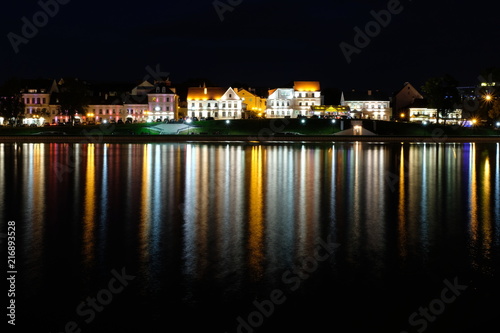 Troickoe predmeste is a picturesque old quarter on the bank of the Svisloch River in the center of Minsk. The night city is reflected in the river. © Ирина Рачинская