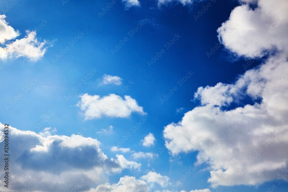 The blue sky with clouds. Spring, winter or summer heaven. Vivid background The blue sky with clouds. Spring, winter or summer heaven. Vivid background