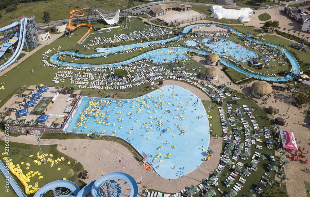 People have a relax in the water park outdoors. Photo from the air