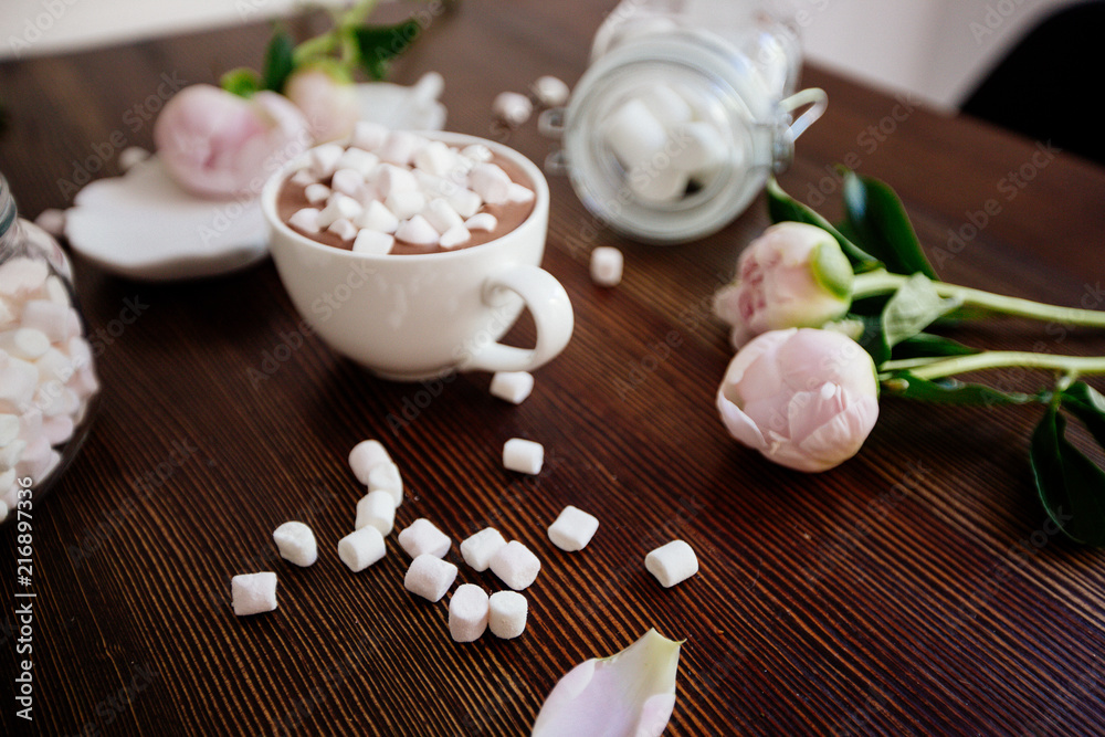 Cocoa with marshmallow and flowers.