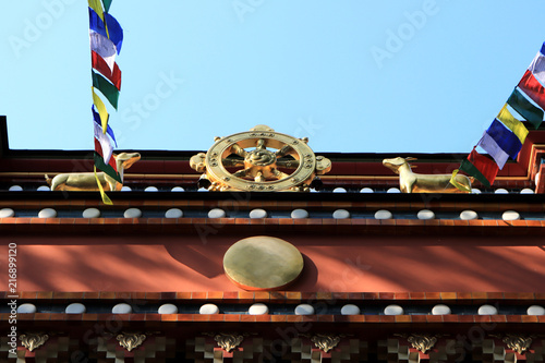 Gold figures of two deer and a wheel on the top of the facade of the building. Buddhist traditional sangha of Russia. Datsan Gunzehoyney. photo