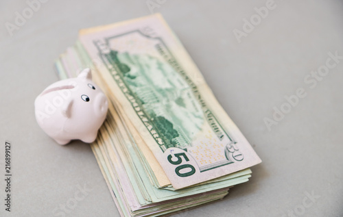 Piggy bank with a lot of American Dollars; investment and banking concepts