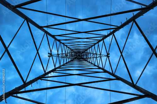 Inside high voltage power pole against evening sky