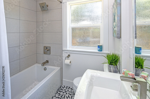 White bathroom design with pedestal sink.