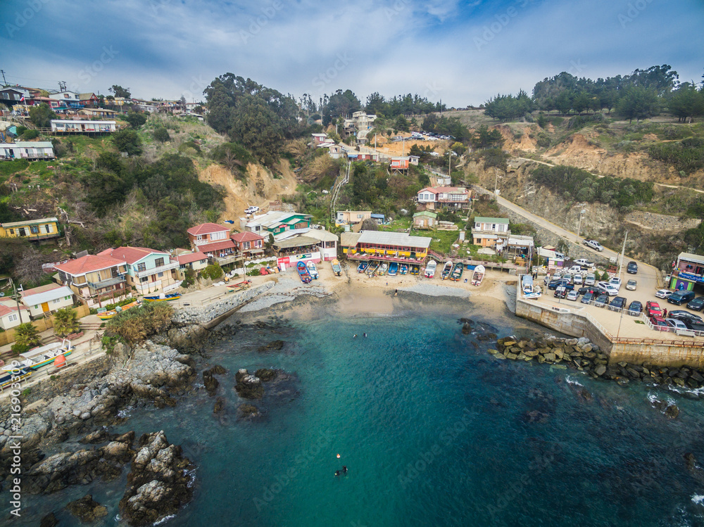 Fototapeta premium Aerial front view of a cove village in the sea