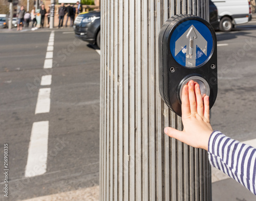 Photography Cropped view of child's hand pushing an Australian pedestrian crossing button (s