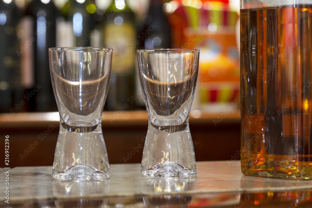 Two empty glasses and full wisky bottle Two empty glasses and full wisky bottle