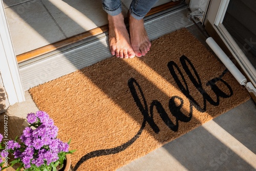 welcome mat in front of new home photo