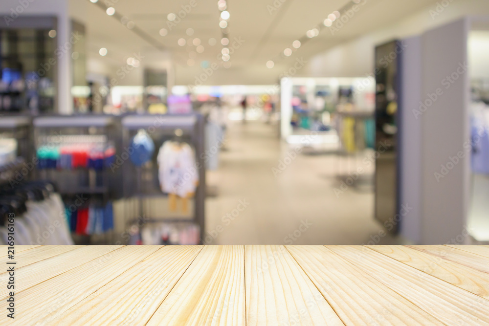 Obraz premium Empty wood table with woman fashionable boutique clothing store window display in shopping mall