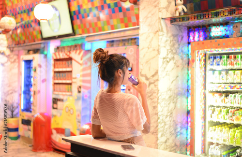 Roiet, Thailand - 26 Dec, 2016 :  an unidentifed woman posting in front of Colorful Japanese vending machines
