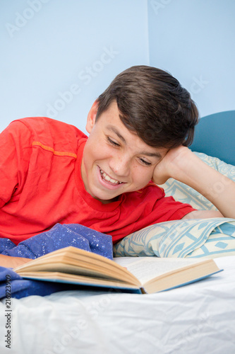 Teenage boy reading a book