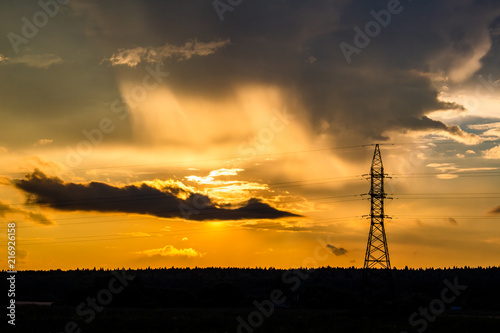 Bright beautiful sunset on the background of power lines