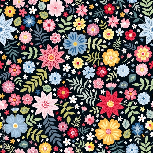 Vibrant ditsy floral seamless pattern with bright summer flowers on dark background. Colorful design for print on fabric, textile, wrapping paper, wallpaper.