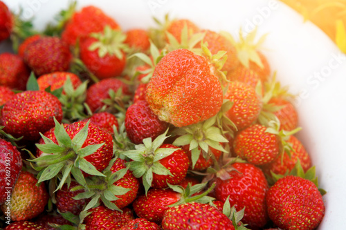 Red strawberry with green leaves. Natural food, a healthy lifestyle. Close-up. Selected focus.