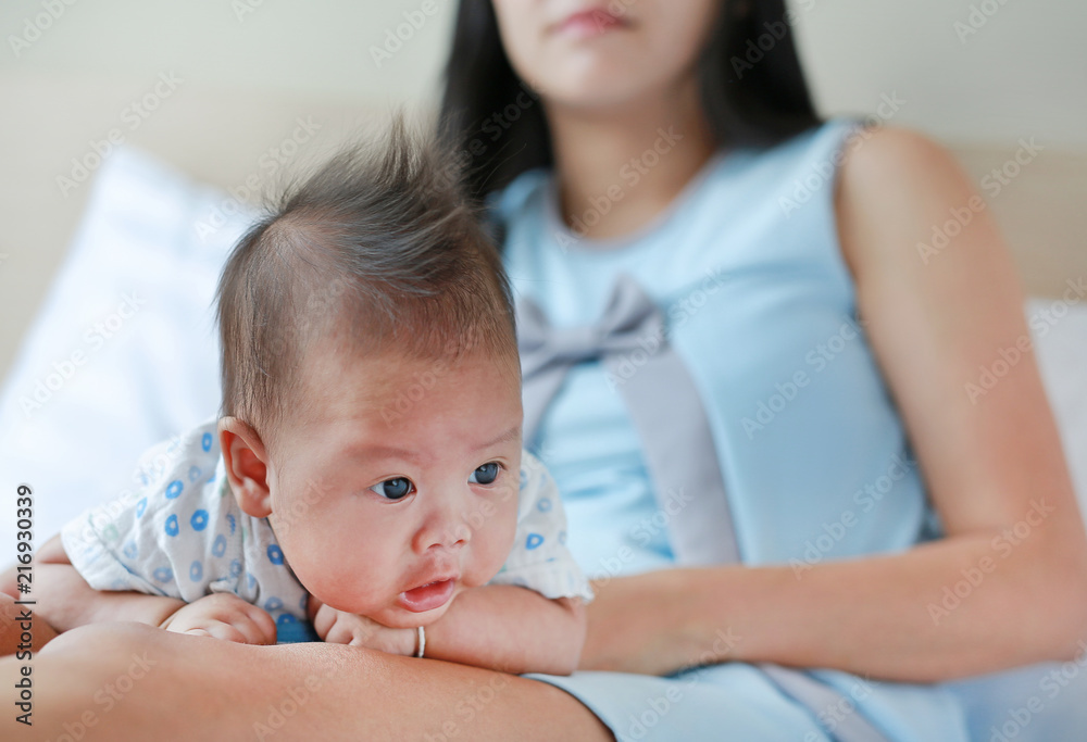 Close up newborn baby boy lying on mother legs.
Close up newborn baby boy lying on mother legs.