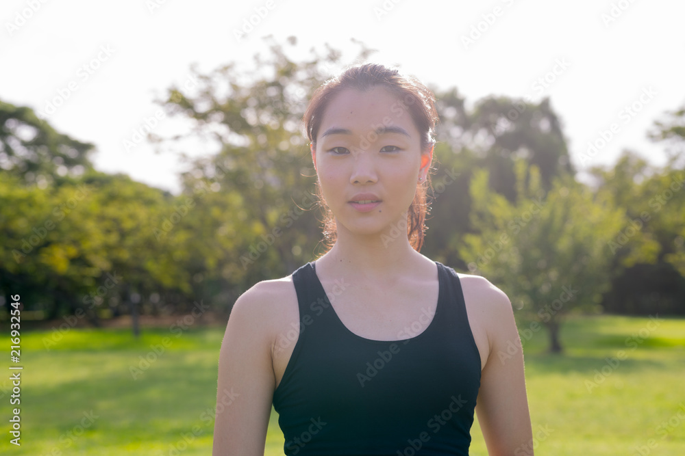 Portrait Of Beautiful Chinese Woman Ready For Exercise In Park Portrait Of Beautiful Chinese Woman Ready For Exercise In Park