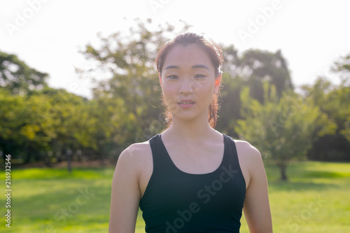 Fototapeta Naklejka Na Ścianę i Meble -  Portrait Of Beautiful Chinese Woman Ready For Exercise In Park