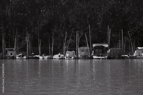 Small Fishing Boats Anchored at Rivers Shore photo