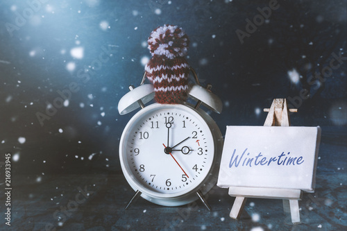 Wintertime reminder: alarmclock with a little sign photo