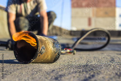 Obraz na plátne Roll roofing Installation with propane blowtorch during construction works