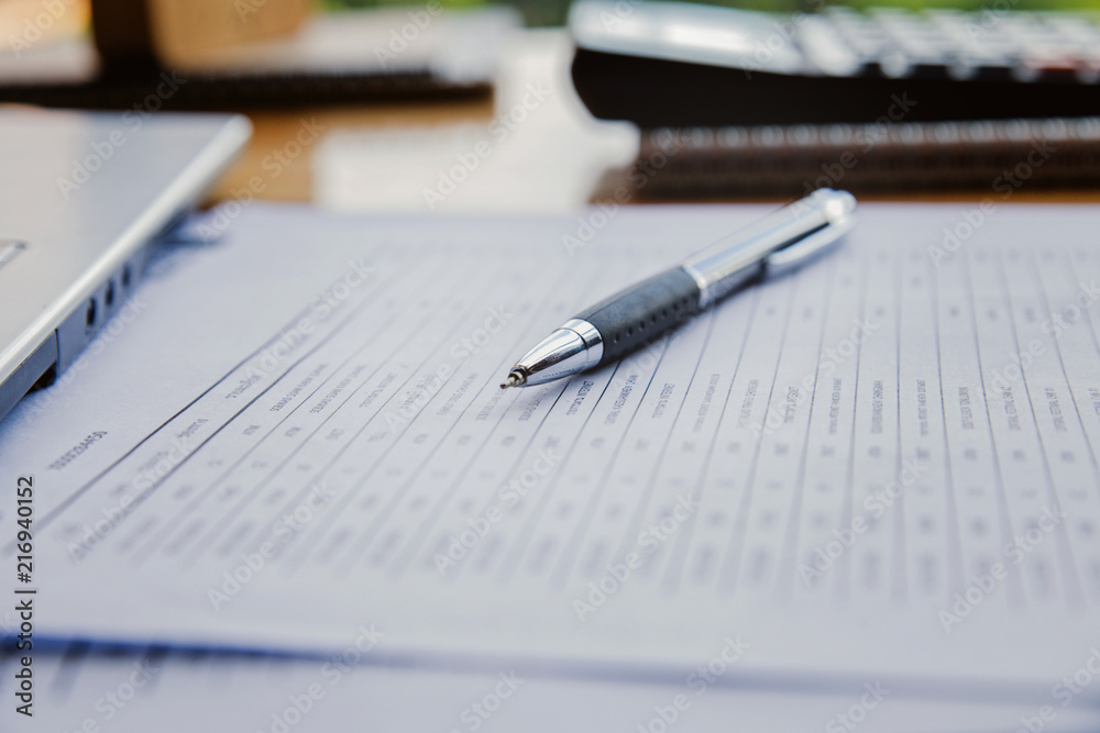 Close-up of pen on document at workplace. Close-up of pen on document at workplace.