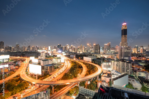 Aerial view skyscraper building with traffic glowing on elevated road