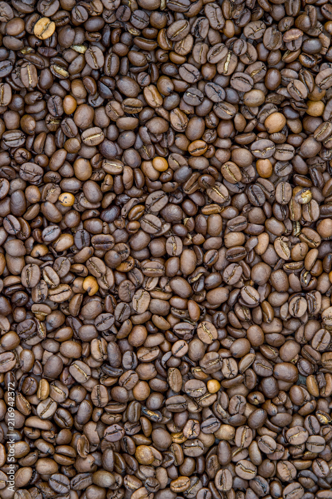 Close-up view of roasted coffee beans in man's hands. Close-up view of roasted coffee beans in man's hands.