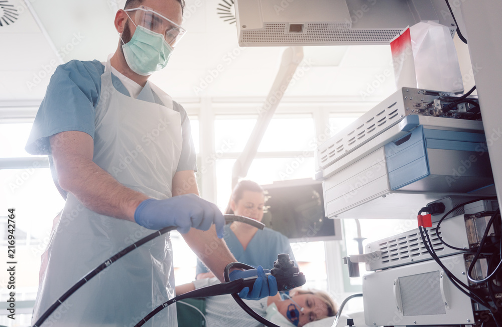Internist doctors during stomach examination working as a team Internist doctors during stomach examination working as a team