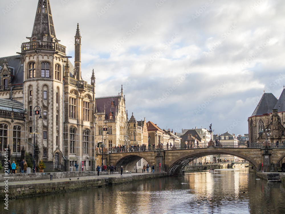 Gent - Medieval cathedral and bridge over a canal in Ghent, Belgium. December, 2017