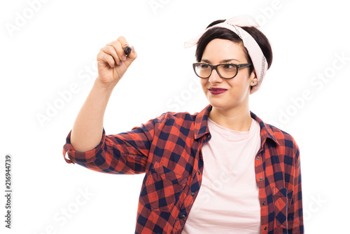 Pretty pin-up girl wearing glasses drawing with black marker.