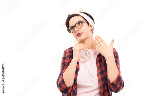 Pretty pin-up girl wearing glasses cooling with bottle of water.