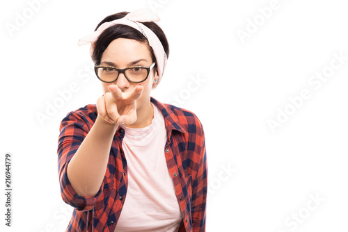 Young pretty pin-up girl showing watching you gesture.