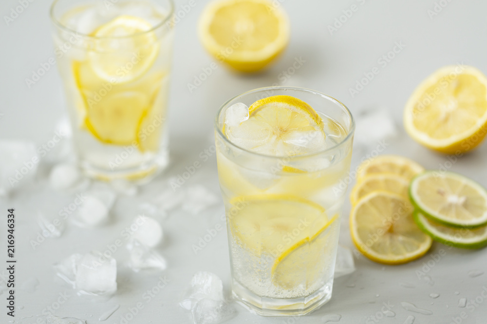 Alcoholic drink (gin and tonic) with lemon, lime, mint and ice. Alcoholic drink (gin and tonic) with lemon, lime, mint and ice.