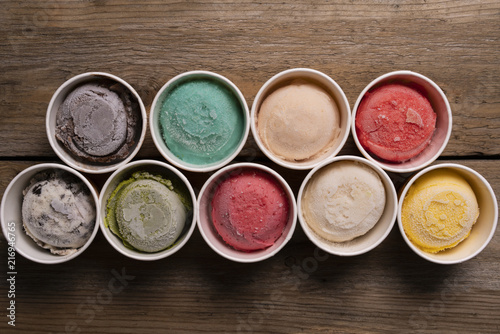 Top view of Ice cream flavors in cup and topping, sweet and dessert food concept