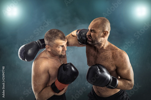 Two professional boxers, athletes in dynamic boxing action © Andrii IURLOV